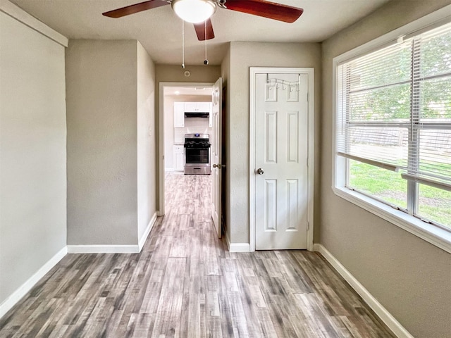5813 Mayle St, Houston, TX 77016 - hall with healthy amount of natural light, wood finished floors, and baseboards