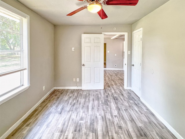 5813 Mayle St, Houston, TX 77016 - empty room with ceiling fan, wood finished floors, and baseboards