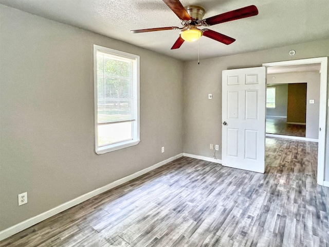 5813 Mayle St, Houston, TX 77016 - spare room featuring healthy amount of natural light, ceiling fan, wood finished floors, and baseboards