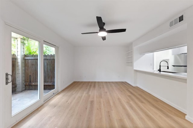 815 Lyle W Ave Unit A, Cleveland, TX 77327 - unfurnished room featuring light wood finished floors, a ceiling fan, baseboards, and a sink