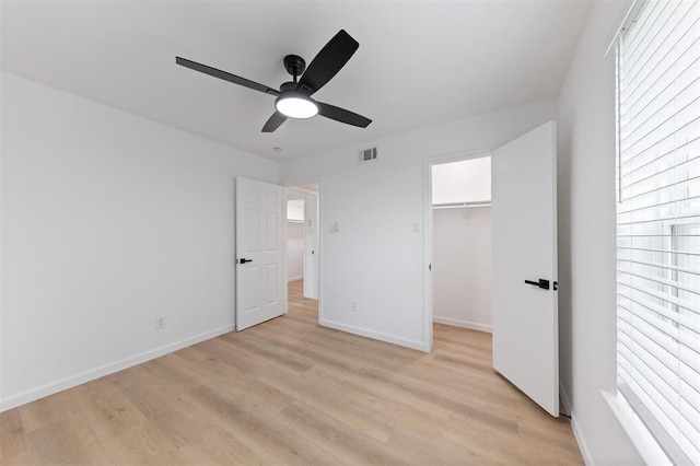 815 Lyle W Ave Unit A, Cleveland, TX 77327 - unfurnished bedroom with baseboards, light wood finished floors, and a walk in closet