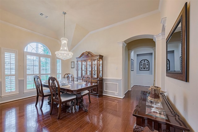 13719 Highland Cove Dr, Houston, TX 77070 - dining area featuring arched walkways, ornate columns, dark wood-style flooring, a wainscoted wall, and ornamental molding