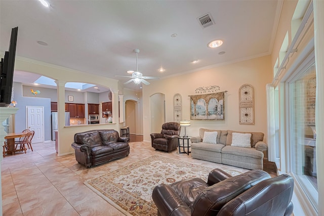 13719 Highland Cove Dr, Houston, TX 77070 - living area featuring arched walkways, a ceiling fan, crown molding, light tile patterned floors, and ornate columns