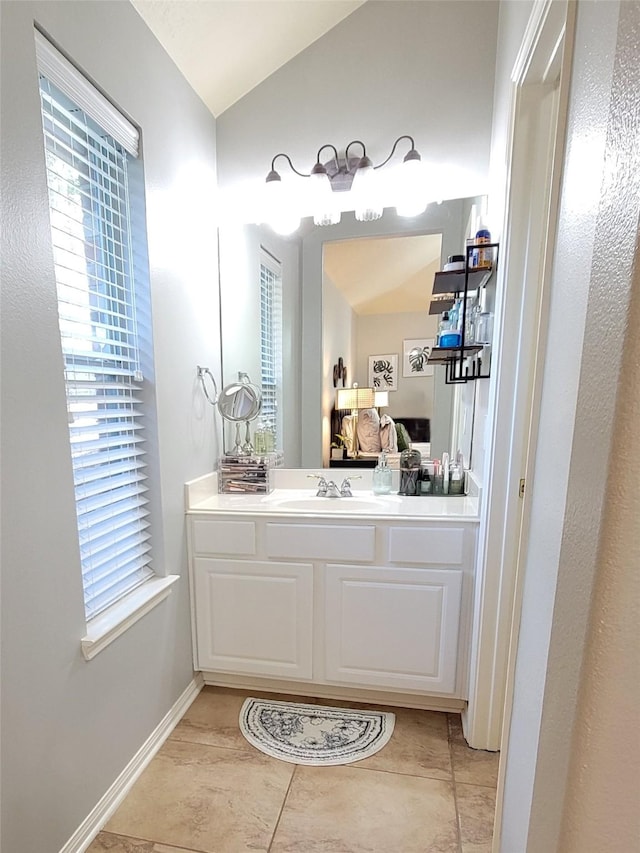 13719 Highland Cove Dr, Houston, TX 77070 - bathroom featuring vanity, healthy amount of natural light, lofted ceiling, connected bathroom, and tile patterned flooring