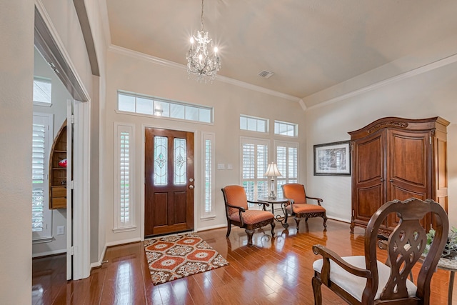 13719 Highland Cove Dr, Houston, TX 77070 - entryway with crown molding, healthy amount of natural light, a chandelier, and hardwood / wood-style floors