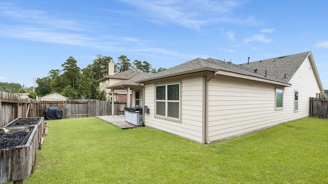 1724 Wandering Hills Rd, Conroe, TX 77304 - back of house with a shingled roof and a garden