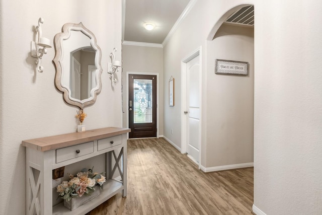 1724 Wandering Hills Rd, Conroe, TX 77304 - foyer entrance with light wood-style flooring, crown molding, and baseboards