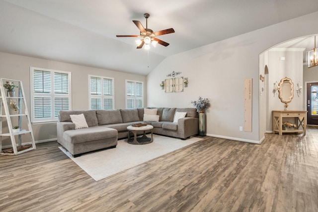 1724 Wandering Hills Rd, Conroe, TX 77304 - living room with wood finished floors, arched walkways, healthy amount of natural light, lofted ceiling, and a ceiling fan