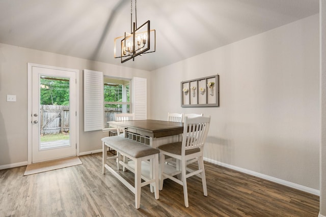 1724 Wandering Hills Rd, Conroe, TX 77304 - dining space with baseboards, wood finished floors, a chandelier, and vaulted ceiling