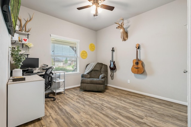 1724 Wandering Hills Rd, Conroe, TX 77304 - home office featuring light wood-style floors, a ceiling fan, and baseboards