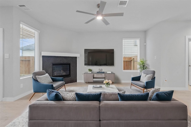 6630 Old Cypress Landing Ln, Humble, TX 77338 - living area with ceiling fan, a glass covered fireplace, and baseboards