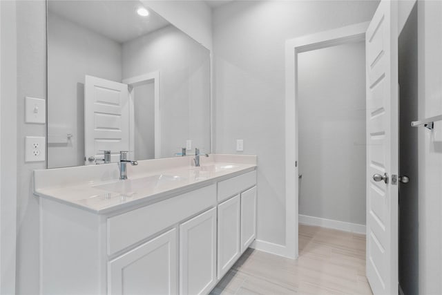 6630 Old Cypress Landing Ln, Humble, TX 77338 - bathroom with double vanity, baseboards, and recessed lighting
