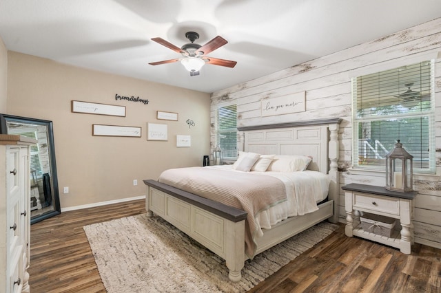 259 Adobe Ter S, Conroe, TX 77316 - bedroom featuring wood walls, dark wood-type flooring, baseboards, and a ceiling fan