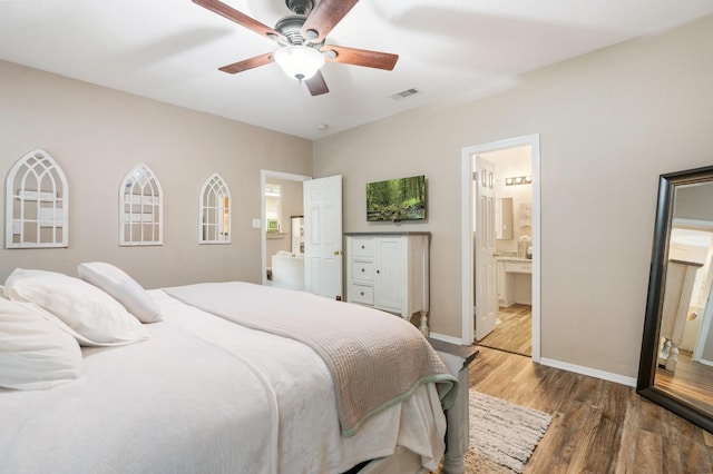 259 Adobe Ter S, Conroe, TX 77316 - bedroom with wood finished floors, baseboards, a ceiling fan, and ensuite bathroom