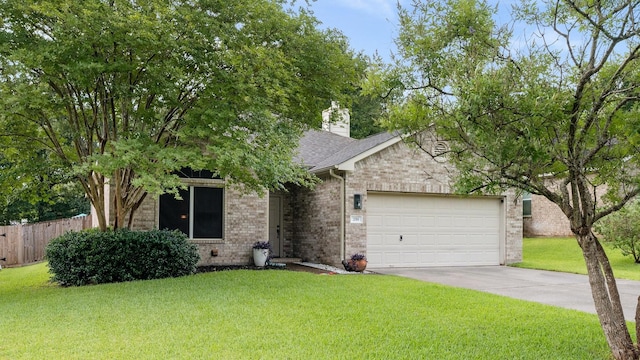 259 Adobe Ter S, Conroe, TX 77316 - view of front of house featuring an attached garage, brick siding, concrete driveway, roof with shingles, and a chimney