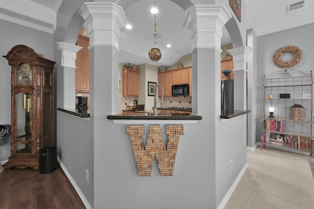 17419 Crescent Canyon Dr, Houston, TX 77095 - kitchen featuring decorative columns, black microwave, dark countertops, and freestanding refrigerator
