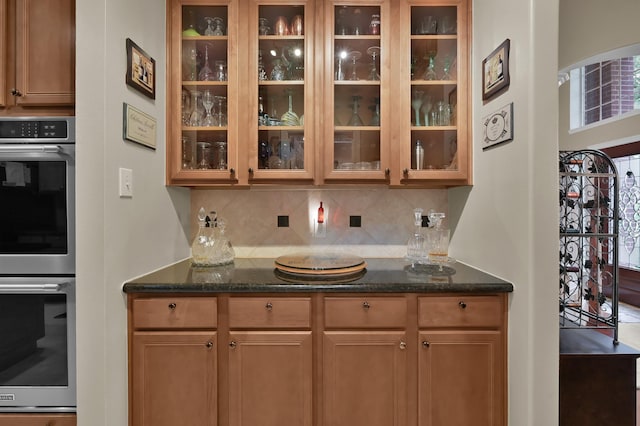 17419 Crescent Canyon Dr, Houston, TX 77095 - bar area with stainless steel double oven, tasteful backsplash, and arched walkways
