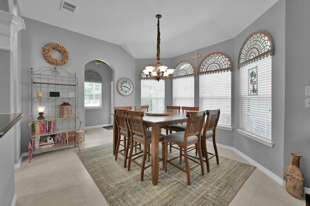 17419 Crescent Canyon Dr, Houston, TX 77095 - dining area with arched walkways, healthy amount of natural light, light tile patterned floors, a chandelier, and lofted ceiling