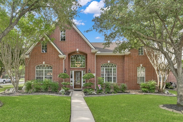 17419 Crescent Canyon Dr, Houston, TX 77095 - view of front of property with brick siding, a front yard, and a shingled roof
