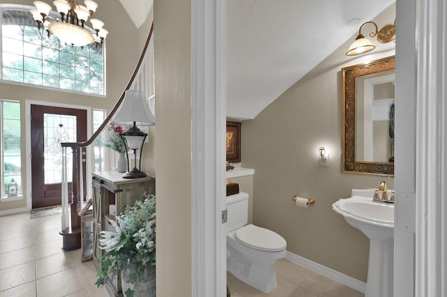 17419 Crescent Canyon Dr, Houston, TX 77095 - half bath featuring tile patterned floors, plenty of natural light, a chandelier, and toilet