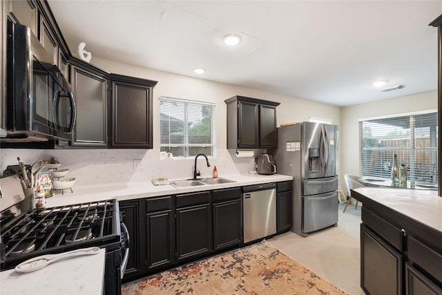 5227 Aberton Ln, Spring, TX 77379 - kitchen with appliances with stainless steel finishes, a sink, healthy amount of natural light, and light countertops