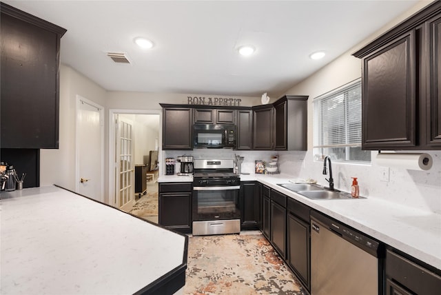 5227 Aberton Ln, Spring, TX 77379 - kitchen featuring stainless steel appliances, a sink, light countertops, dark brown cabinetry, and recessed lighting