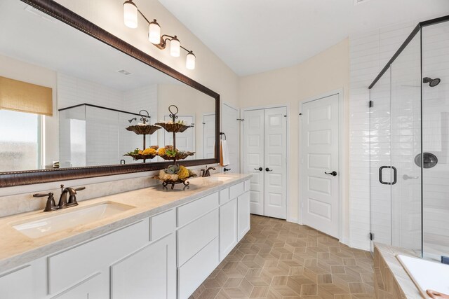 2608 Bisbee Rd, League City, TX 77573 - full bathroom with a stall shower, double vanity, and tiled bath