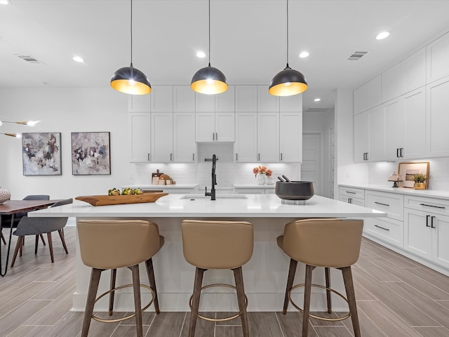 852 Rd 6609, Dayton, TX 77535 - kitchen with tasteful backsplash, light countertops, a kitchen bar, and recessed lighting