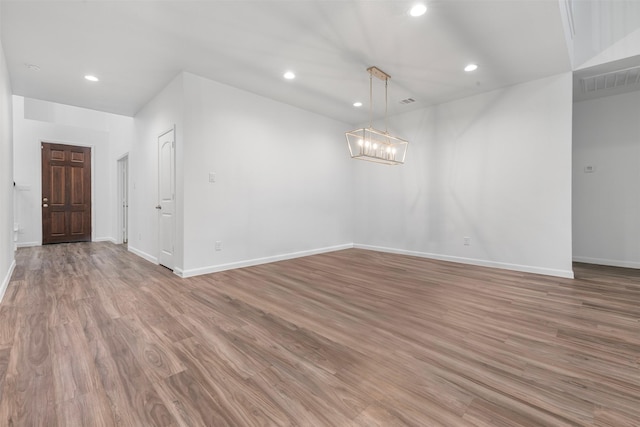 18202 Fehmarn Sound Cir, Houston, TX 77044 - unfurnished room featuring baseboards, recessed lighting, light wood finished floors, and a chandelier
