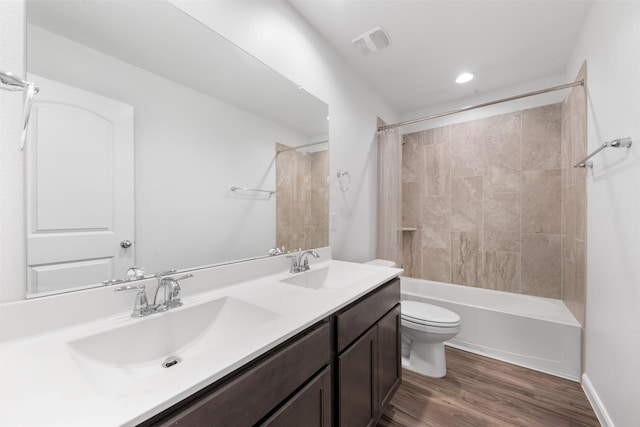 18202 Fehmarn Sound Cir, Houston, TX 77044 - full bathroom featuring double vanity, toilet, shower / bath combination with curtain, and wood finished floors