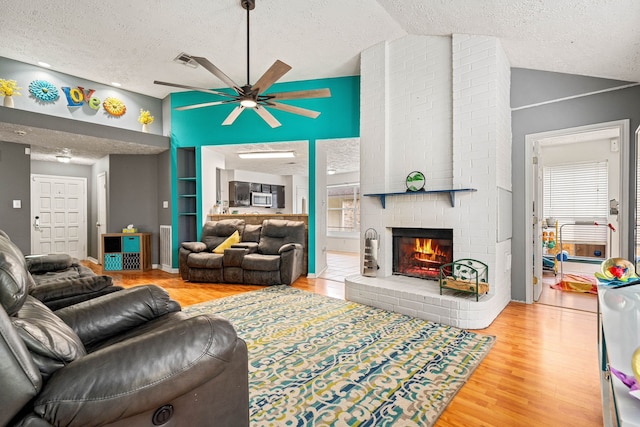 327 Brompton Ct, Highlands, TX 77562 - living room with a textured ceiling, lofted ceiling, wood finished floors, ceiling fan, and plenty of natural light