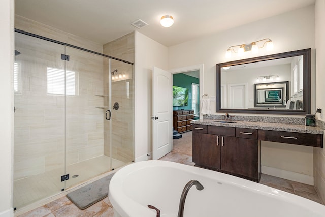300 Bentside Pl, Clute, TX 77531 - bathroom featuring a tub to relax in, a shower stall, and vanity