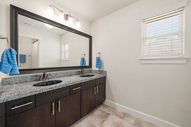 300 Bentside Pl, Clute, TX 77531 - bathroom with baseboards, double vanity, and plenty of natural light