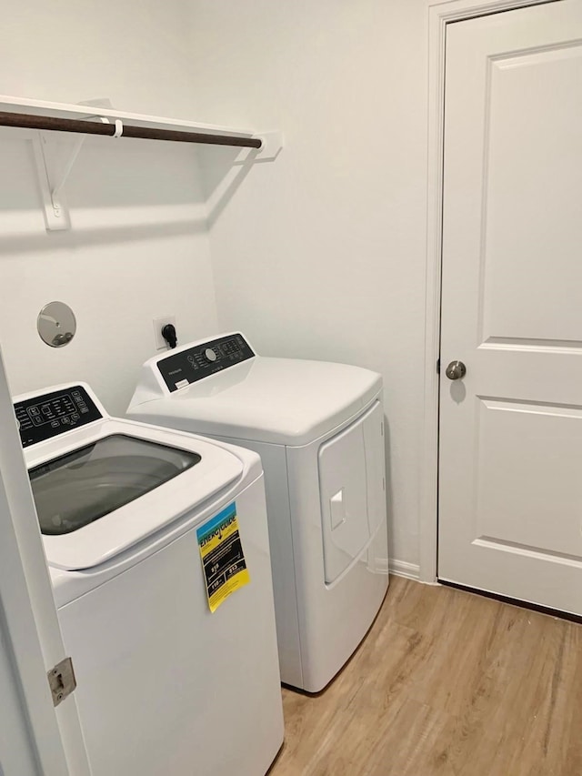 318 Riverwood Village Ln, Sealy, TX 77474 - laundry area featuring independent washer and dryer and light wood-style flooring