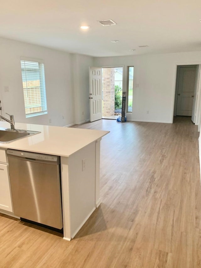 318 Riverwood Village Ln, Sealy, TX 77474 - kitchen with dishwasher, light wood-style flooring, healthy amount of natural light, white cabinetry, and recessed lighting