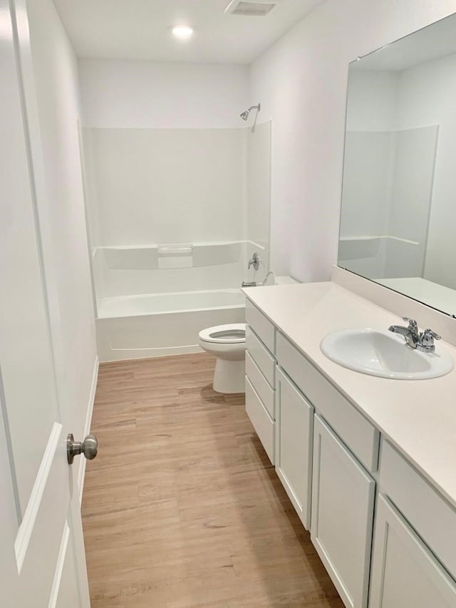 318 Riverwood Village Ln, Sealy, TX 77474 - full bath with vanity, toilet, bathing tub / shower combination, wood finished floors, and recessed lighting
