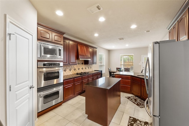 4610 Countrymeadows Dr, Spring, TX 77388 - kitchen featuring appliances with stainless steel finishes, decorative backsplash, recessed lighting, custom range hood, and a kitchen island