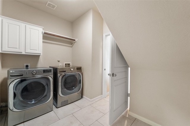 4610 Countrymeadows Dr, Spring, TX 77388 - washroom featuring cabinet space, washing machine and clothes dryer, baseboards, and light tile patterned floors
