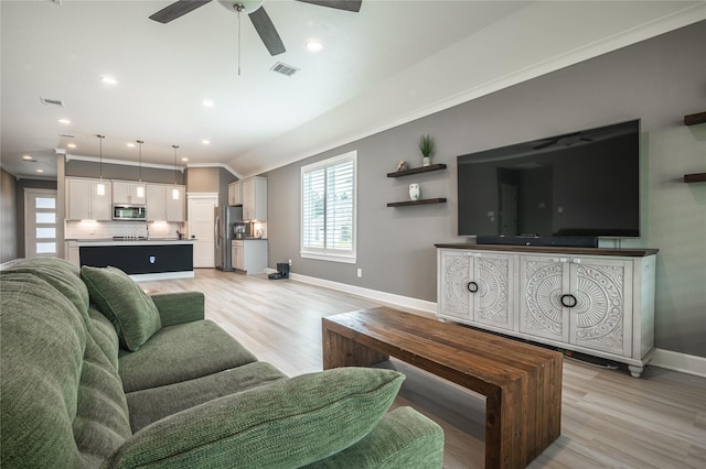 14424 Tunnel Tree Ct, Conroe, TX 77384 - living room with baseboards, ceiling fan, light wood-style floors, ornamental molding, and recessed lighting