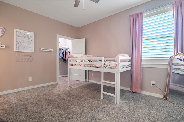 14424 Tunnel Tree Ct, Conroe, TX 77384 - bedroom featuring carpet flooring, a walk in closet, baseboards, and ceiling fan