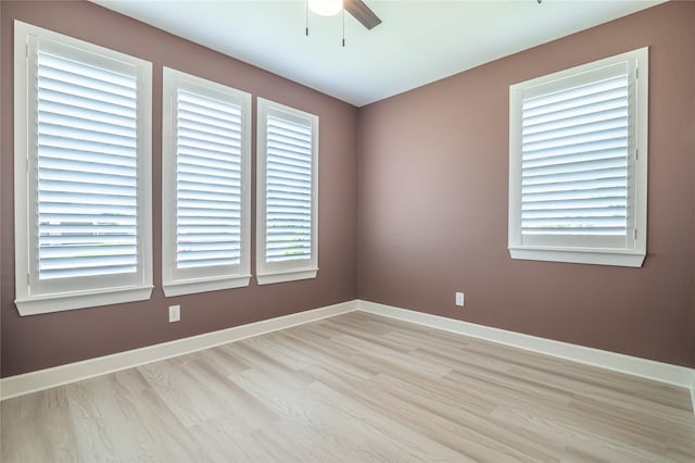 14424 Tunnel Tree Ct, Conroe, TX 77384 - empty room with ceiling fan, light wood-style floors, and baseboards