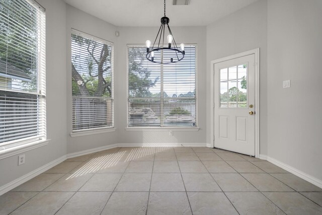 3935 Waverly Bnd, Katy, TX 77450 - unfurnished dining area featuring light tile patterned floors, a chandelier, and baseboards