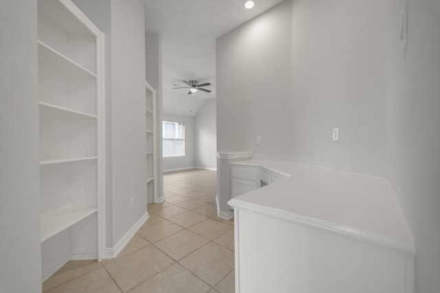 3935 Waverly Bnd, Katy, TX 77450 - corridor featuring light tile patterned floors, built in shelves, baseboards, and vaulted ceiling