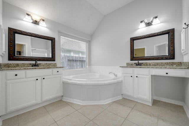 3935 Waverly Bnd, Katy, TX 77450 - full bath with vaulted ceiling, two vanities, a garden tub, and tile patterned floors