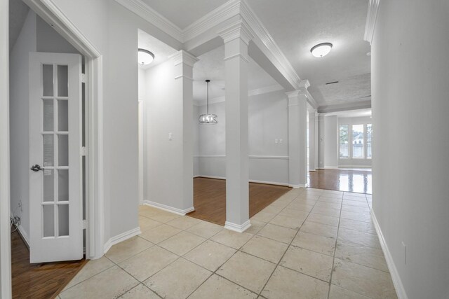 3935 Waverly Bnd, Katy, TX 77450 - corridor featuring ornate columns, crown molding, light tile patterned flooring, and baseboards