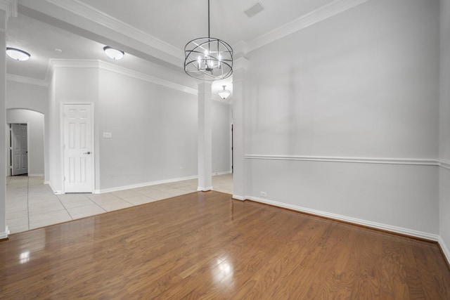 3935 Waverly Bnd, Katy, TX 77450 - empty room with arched walkways, ornamental molding, a chandelier, decorative columns, and baseboards