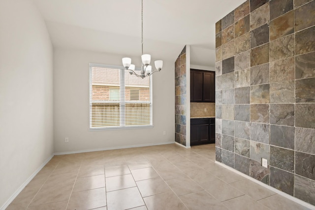 14021 Buffalo Gap Trl, Conroe, TX 77384 - unfurnished dining area with a chandelier, light tile patterned flooring, and baseboards
