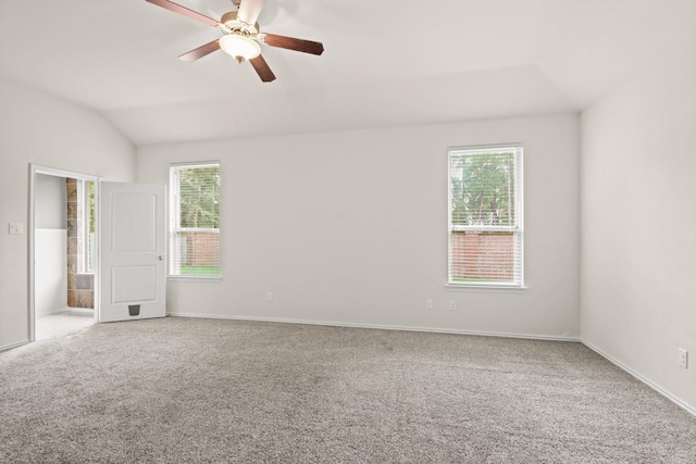 14021 Buffalo Gap Trl, Conroe, TX 77384 - carpeted empty room with vaulted ceiling, healthy amount of natural light, ceiling fan, and baseboards