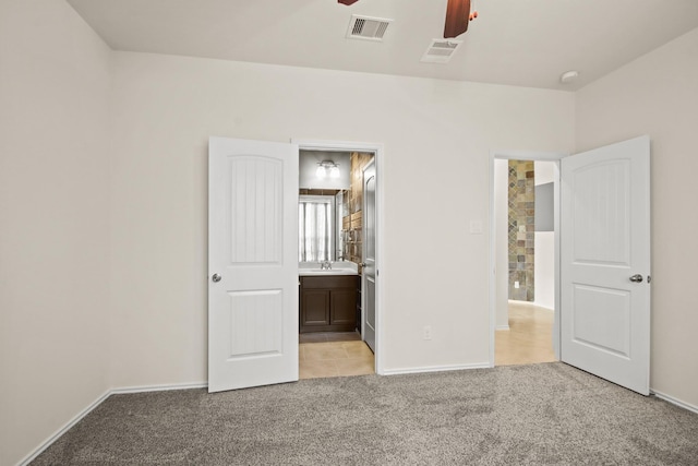 14021 Buffalo Gap Trl, Conroe, TX 77384 - unfurnished bedroom featuring light colored carpet, baseboards, a sink, and ensuite bathroom