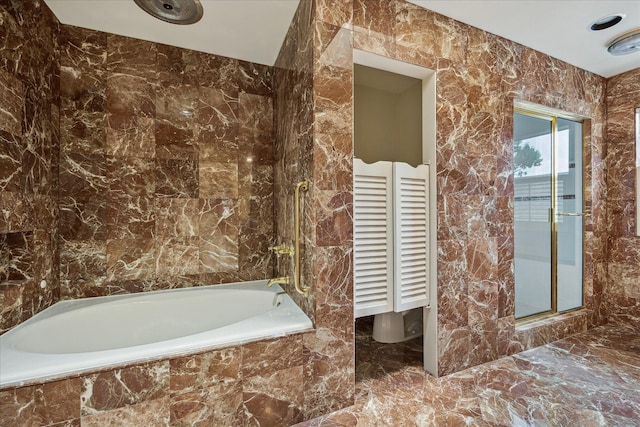 2628 Glen Haven Blvd, Houston, TX 77025 - bathroom with marble tiled flooring and tile walls
